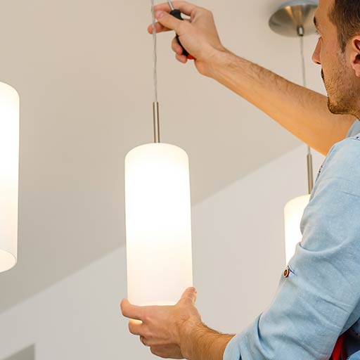 electrician installing new cylinder lights